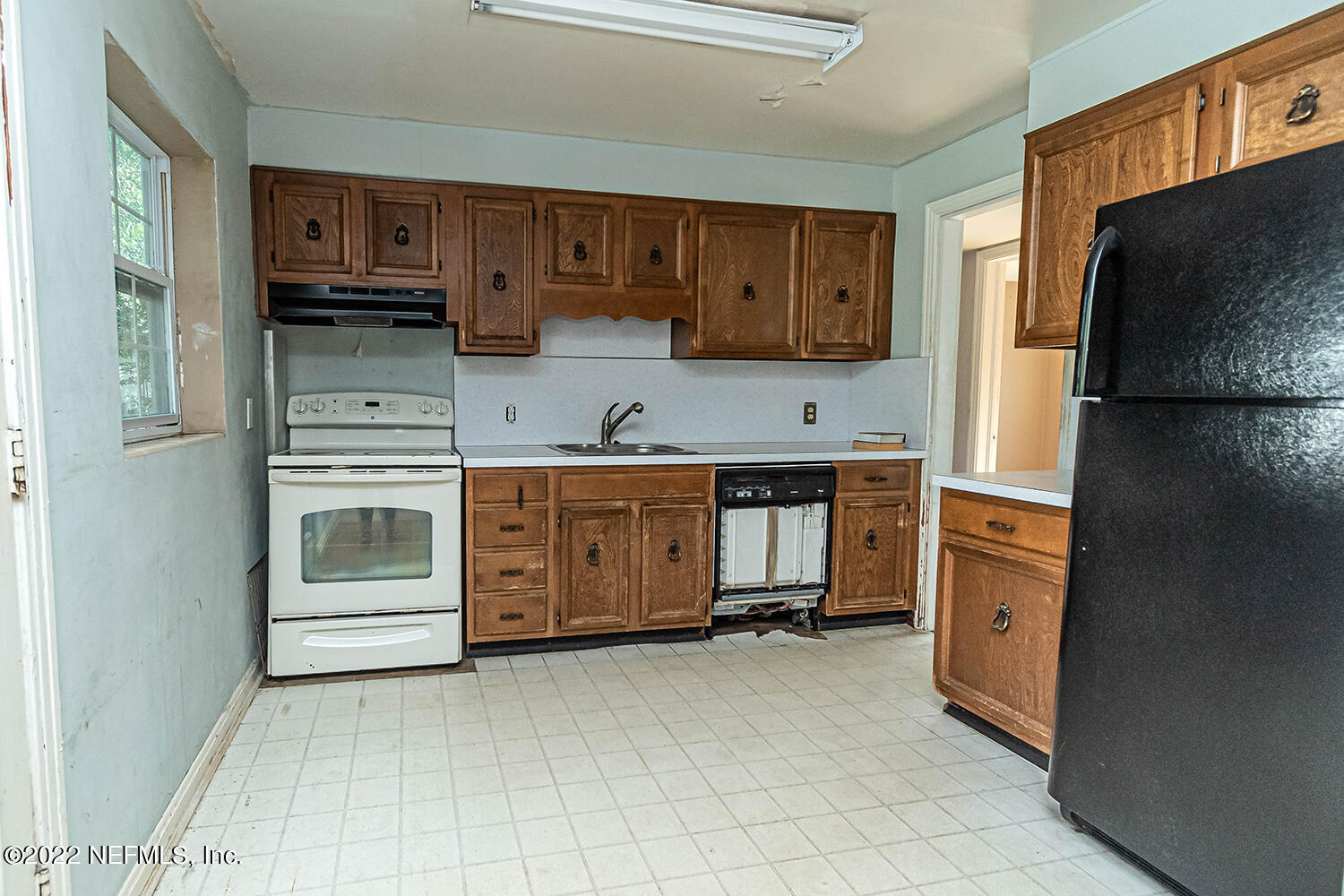 2445 Community Road Jacksonville, FL 32207 - Photo 20 of 42 a kitchen with a refrigerator and a stove