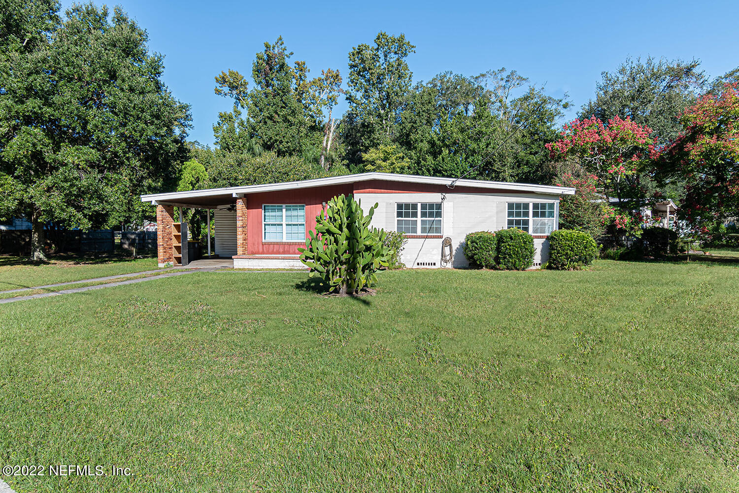 2445 Community Road Jacksonville, FL 32207 - Photo 2 of 42 a house with green field in front of it