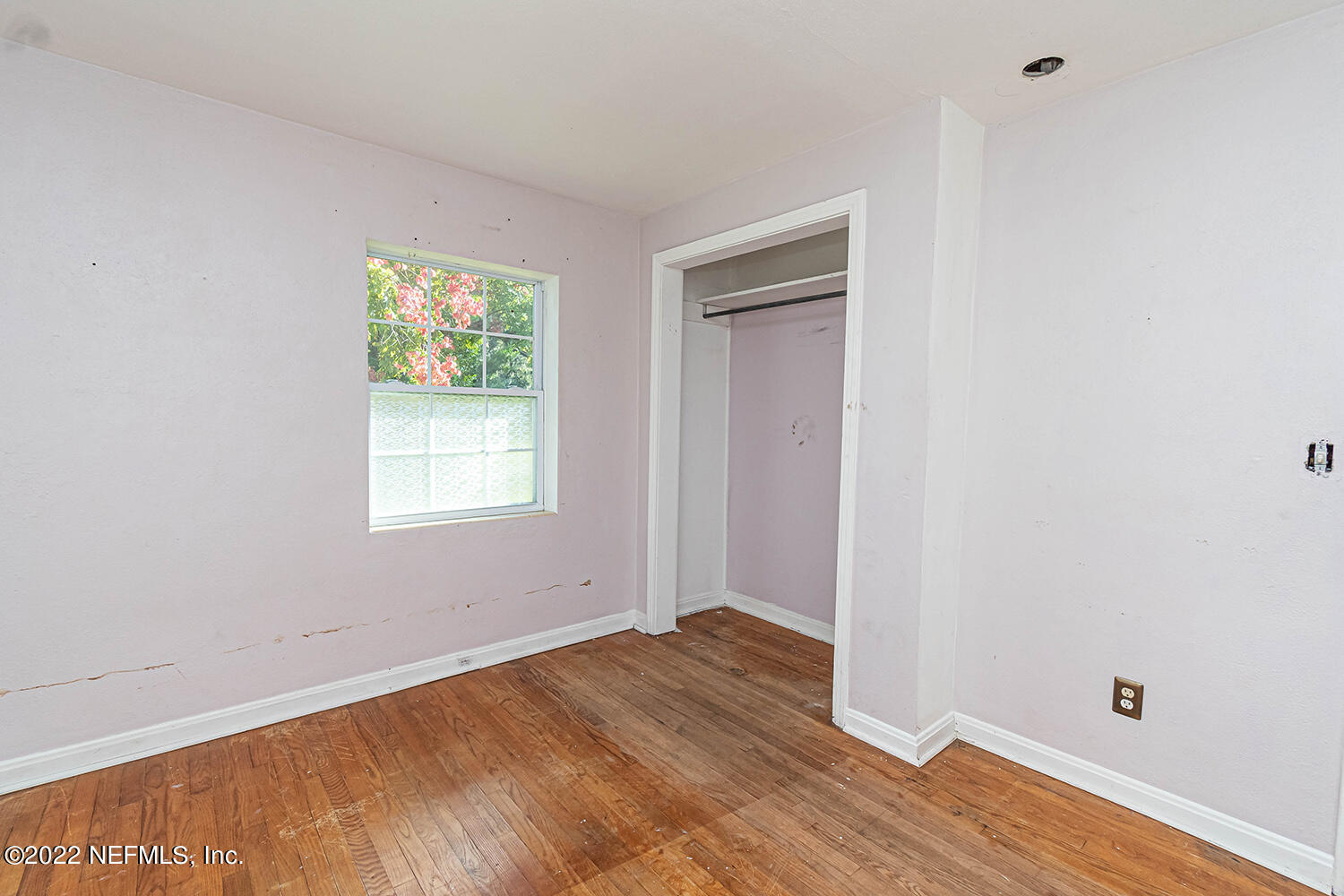 2445 Community Road Jacksonville, FL 32207 - Photo 27 of 42 a view of an empty room with wooden floor and a window