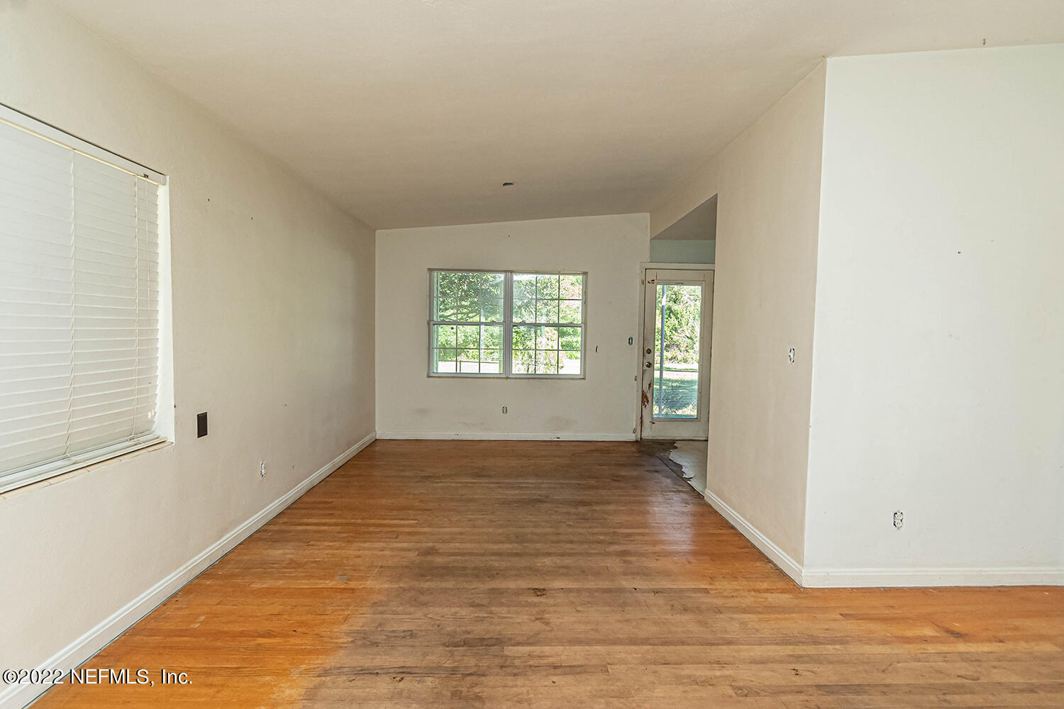 2445 Community Road Jacksonville, FL 32207 - Photo 31 of 42 an empty room with wooden floor and windows