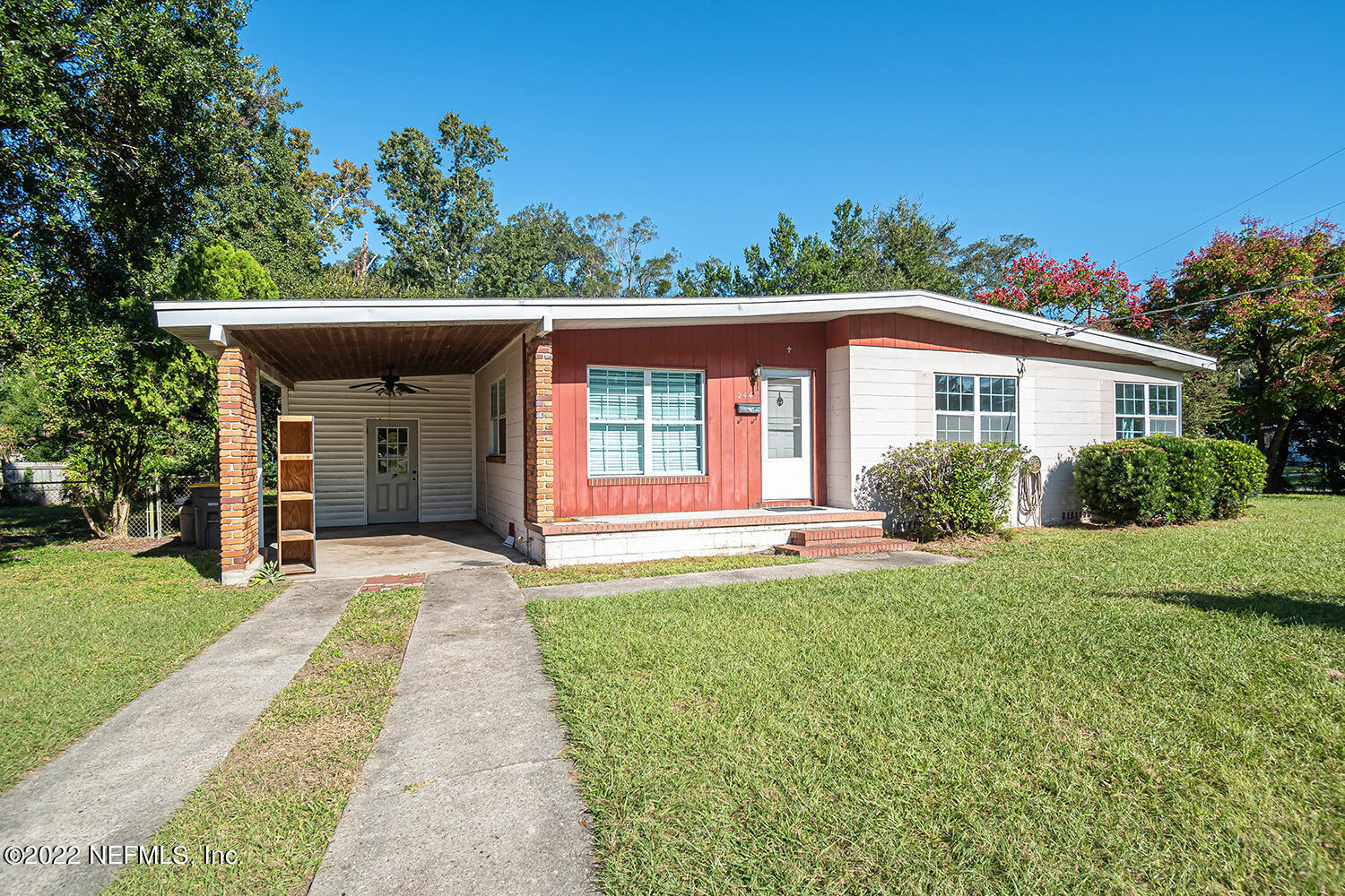 2445 Community Road Jacksonville, FL 32207 - Photo 4 of 42 a front view of a house with a yard and potted plants
