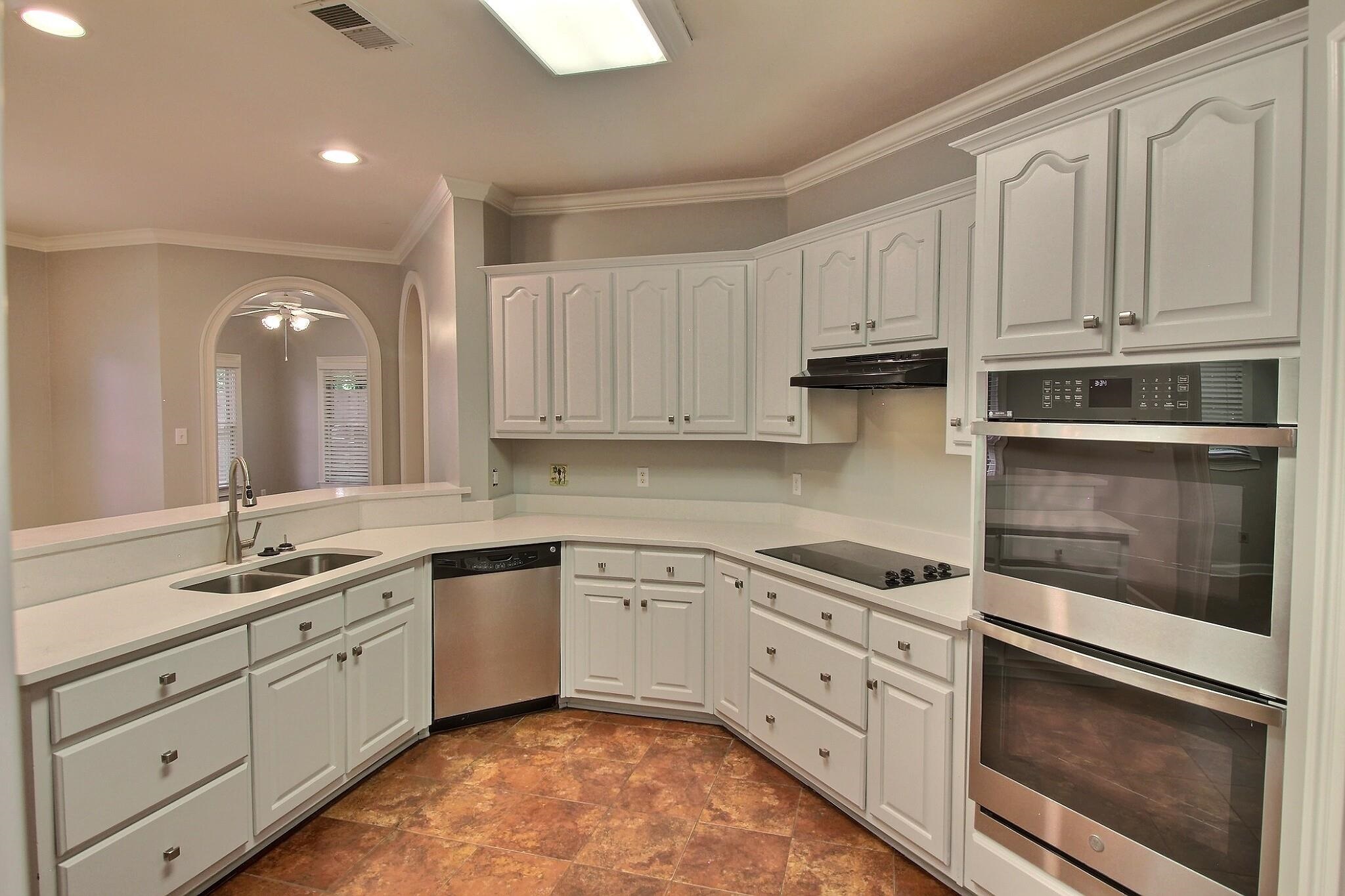 255 Ellawood Lane Collierville, TN 38017 - Photo 13 of 38 a kitchen with white cabinets stainless steel appliances and a sink