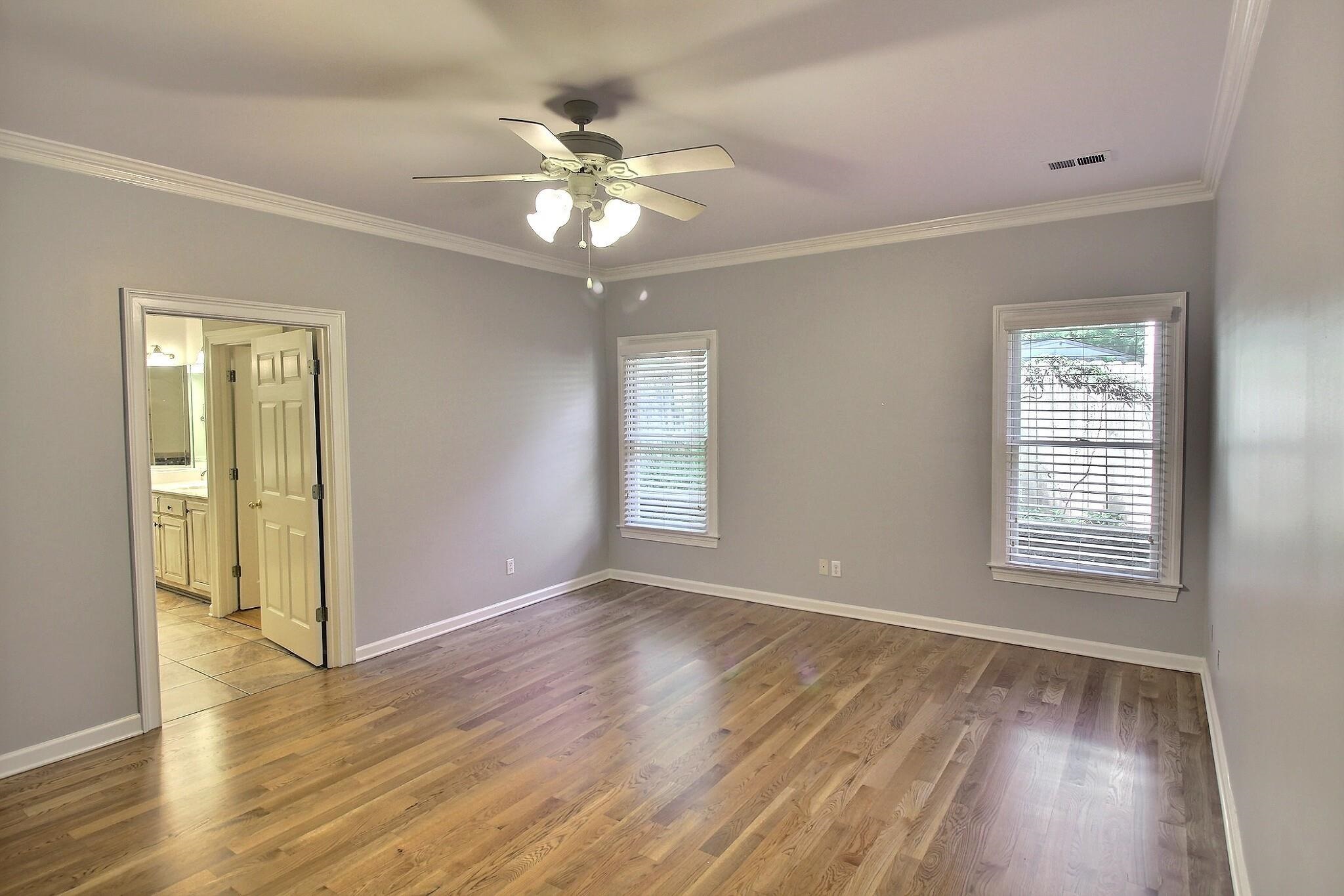 255 Ellawood Lane Collierville, TN 38017 - Photo 18 of 38 a view of an empty room with wooden floor and a window
