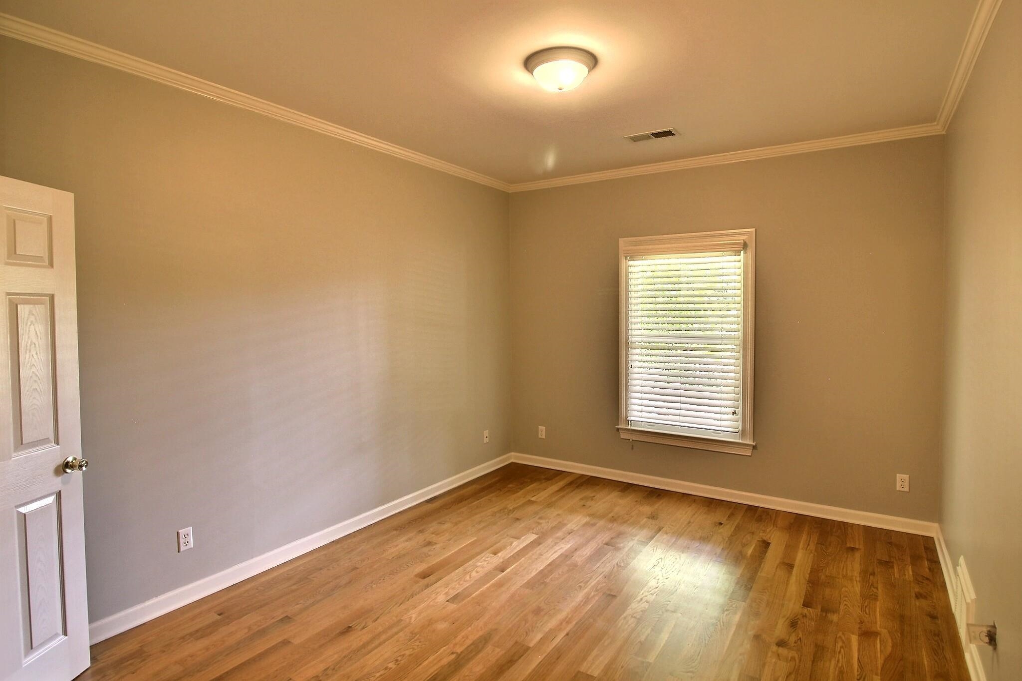 255 Ellawood Lane Collierville, TN 38017 - Photo 21 of 38 a view of an empty room with wooden floor and a window