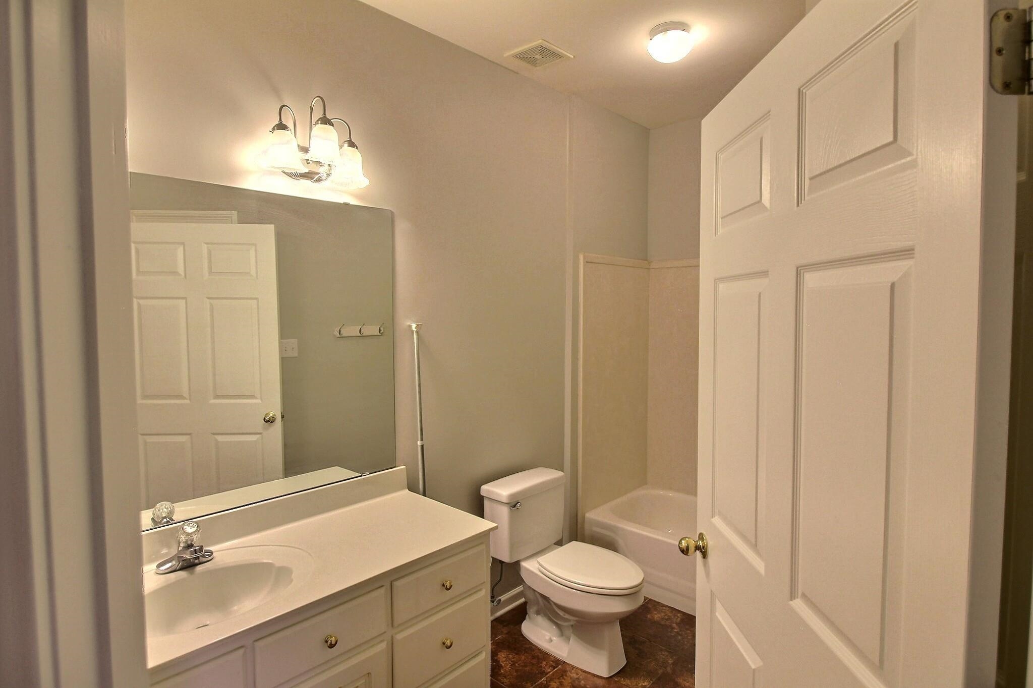 255 Ellawood Lane Collierville, TN 38017 - Photo 22 of 38 a bathroom with a sink a toilet a mirror and shower