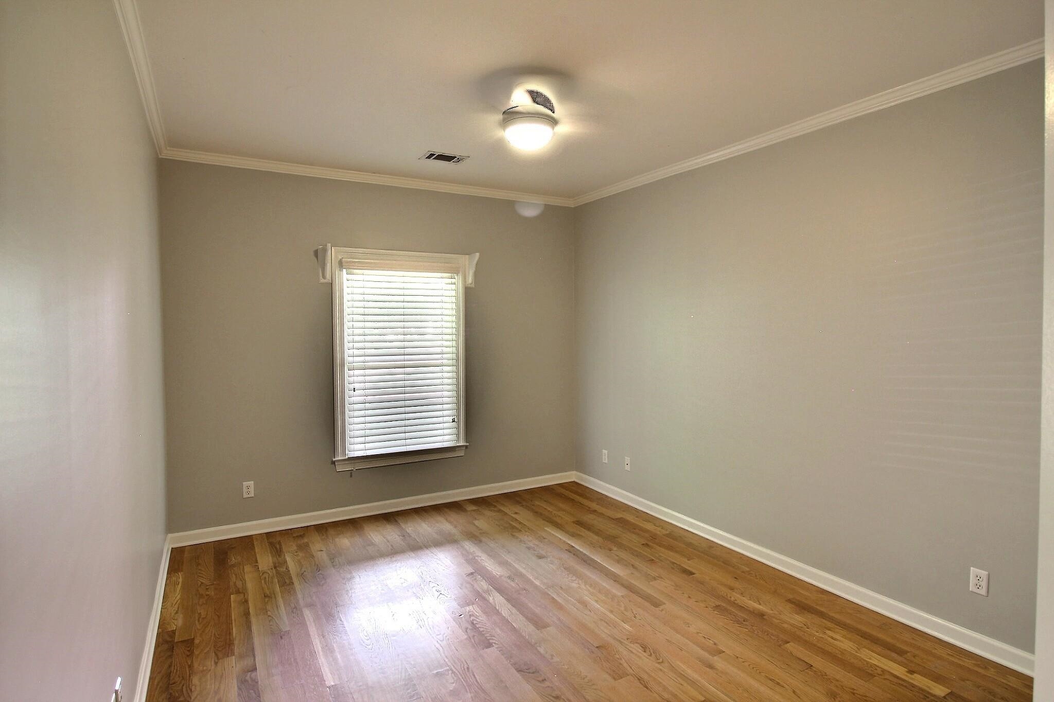 255 Ellawood Lane Collierville, TN 38017 - Photo 23 of 38 an empty room with wooden floor and windows