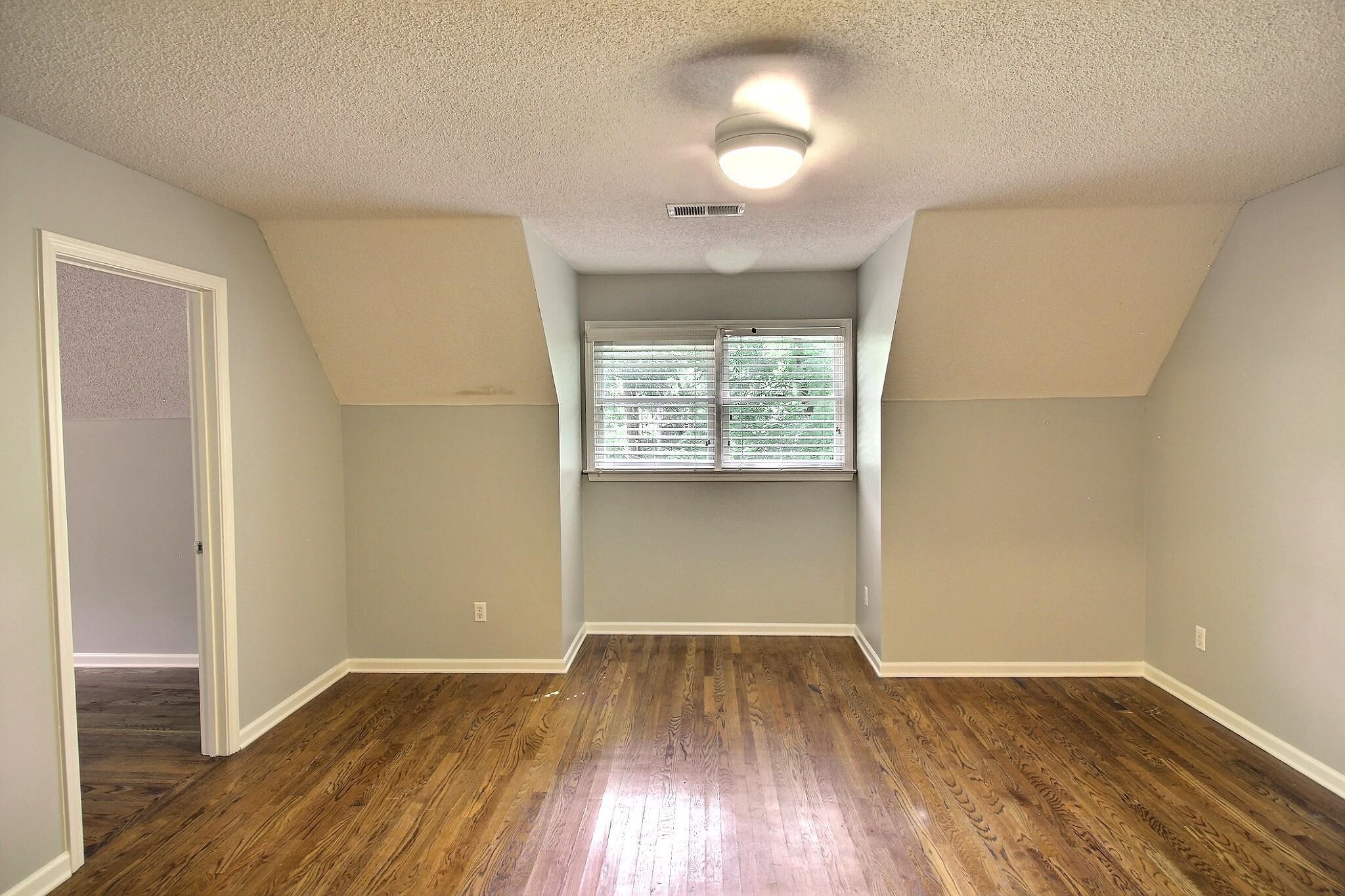 255 Ellawood Lane Collierville, TN 38017 - Photo 26 of 38 an empty room with wooden floor and windows
