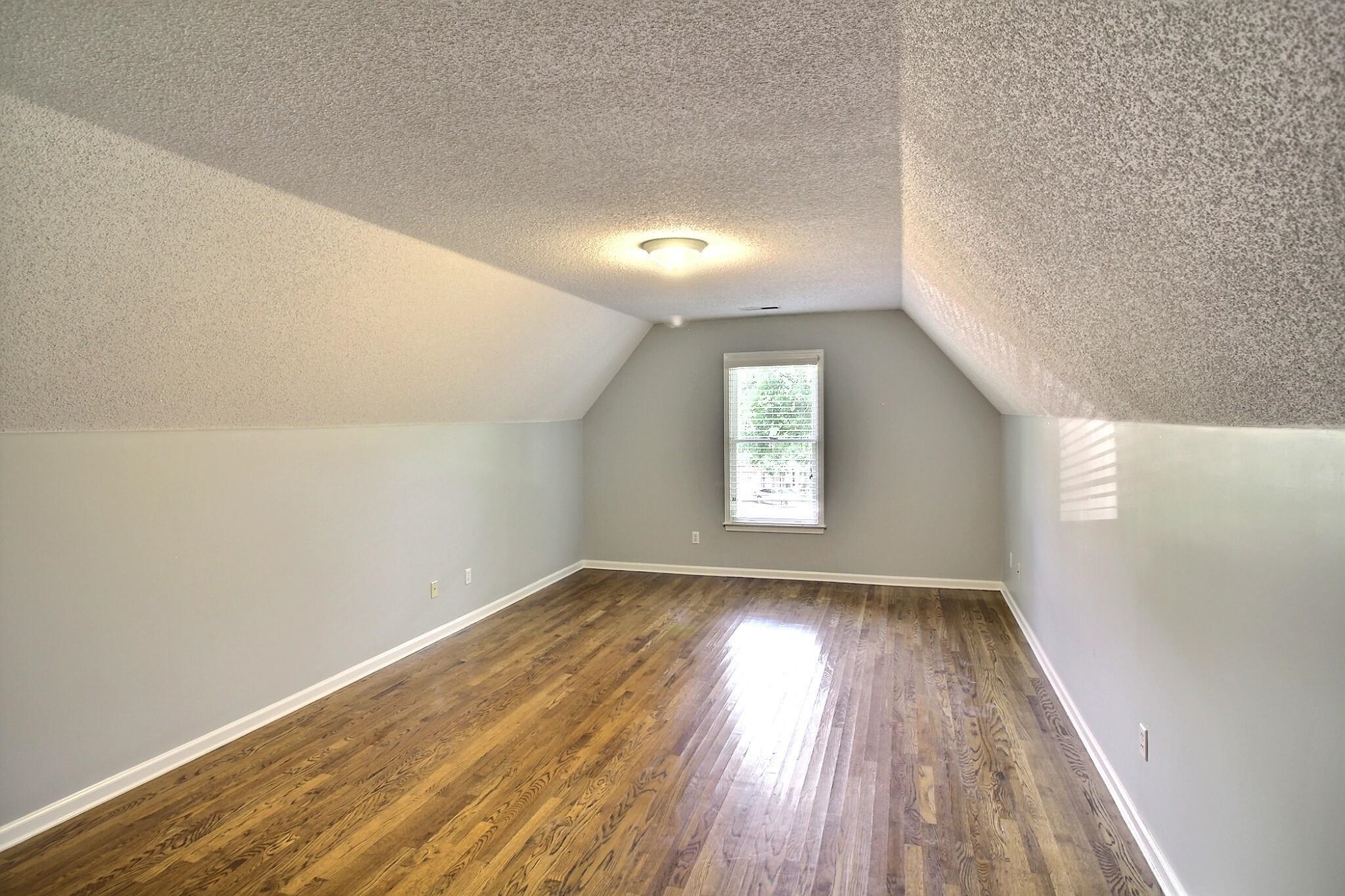 255 Ellawood Lane Collierville, TN 38017 - Photo 27 of 38 wooden floor in an empty room with a window