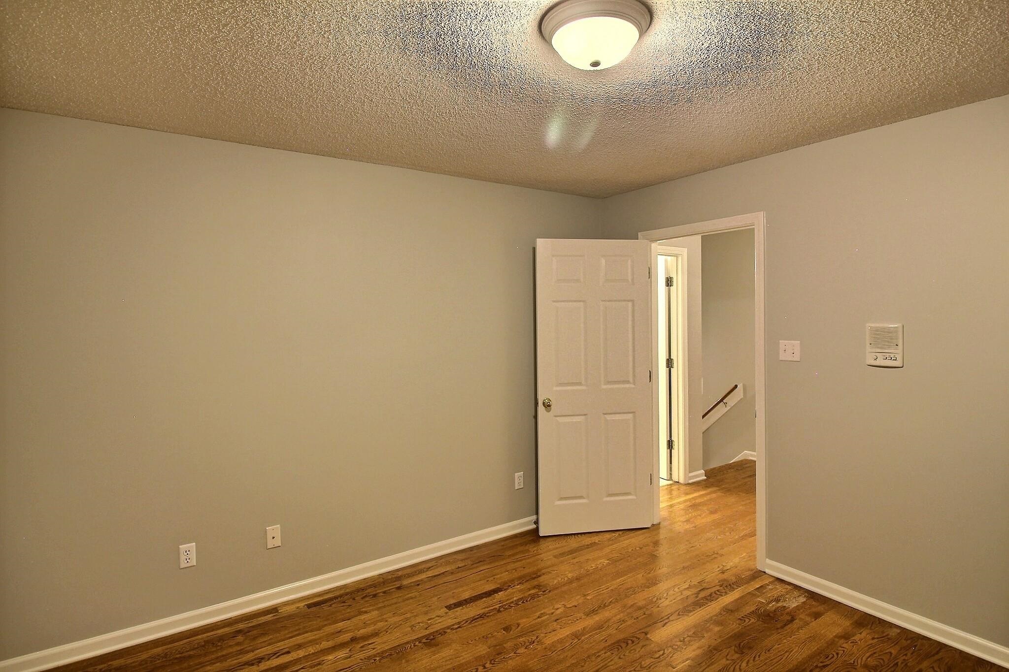 255 Ellawood Lane Collierville, TN 38017 - Photo 29 of 38 an empty room with wooden floor and windows