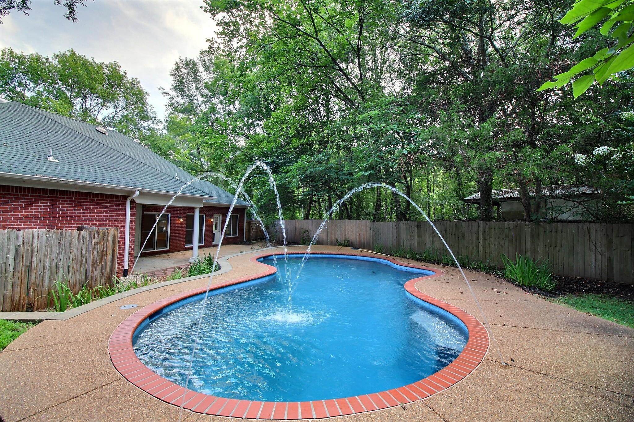255 Ellawood Lane Collierville, TN 38017 - Photo 6 of 38 a view of a swimming pool with a patio