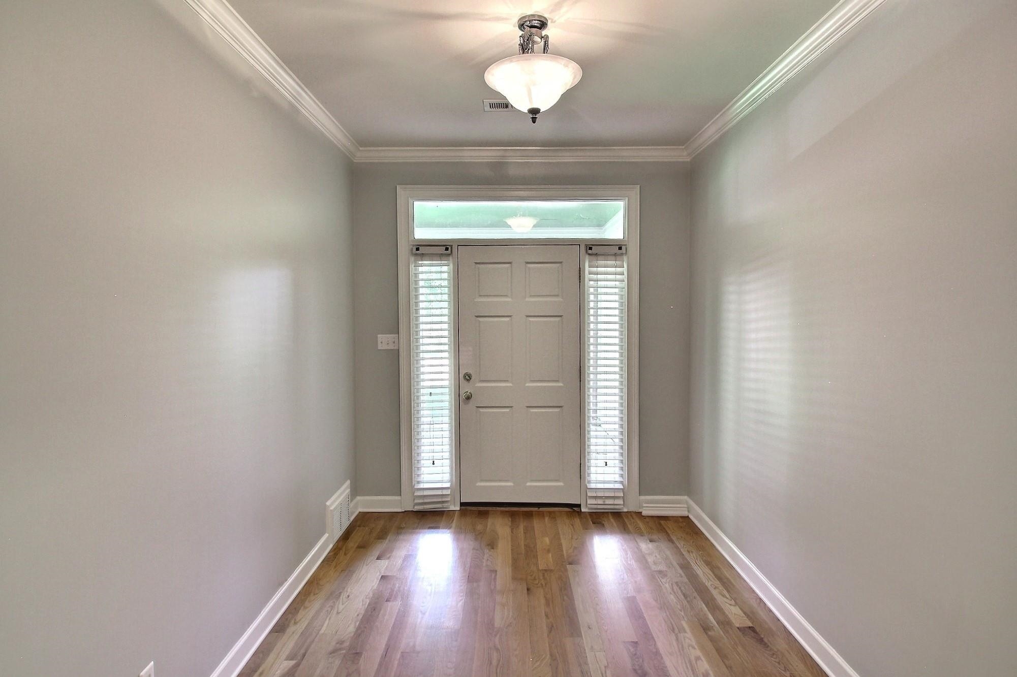 255 Ellawood Lane Collierville, TN 38017 - Photo 9 of 38 an empty room with wooden floor and windows