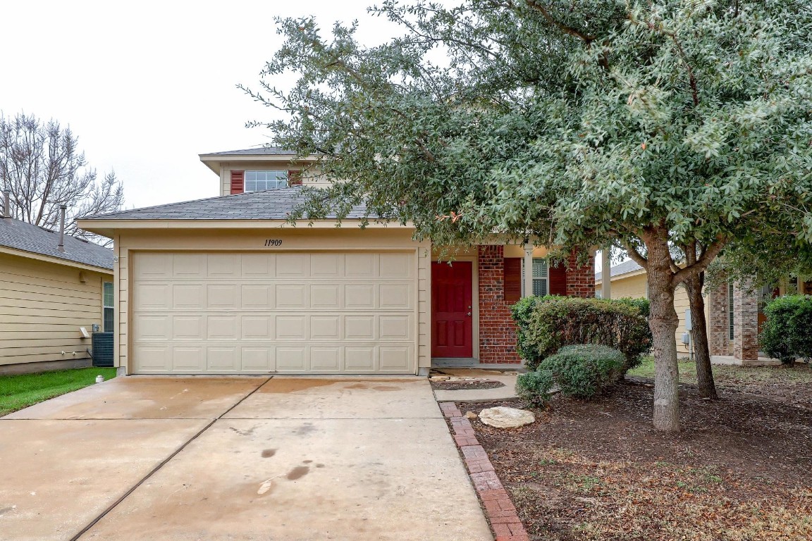 11909 Aitne Lane Austin, TX 78725 - Photo 1 of 1 a front view of a house with a yard and garage