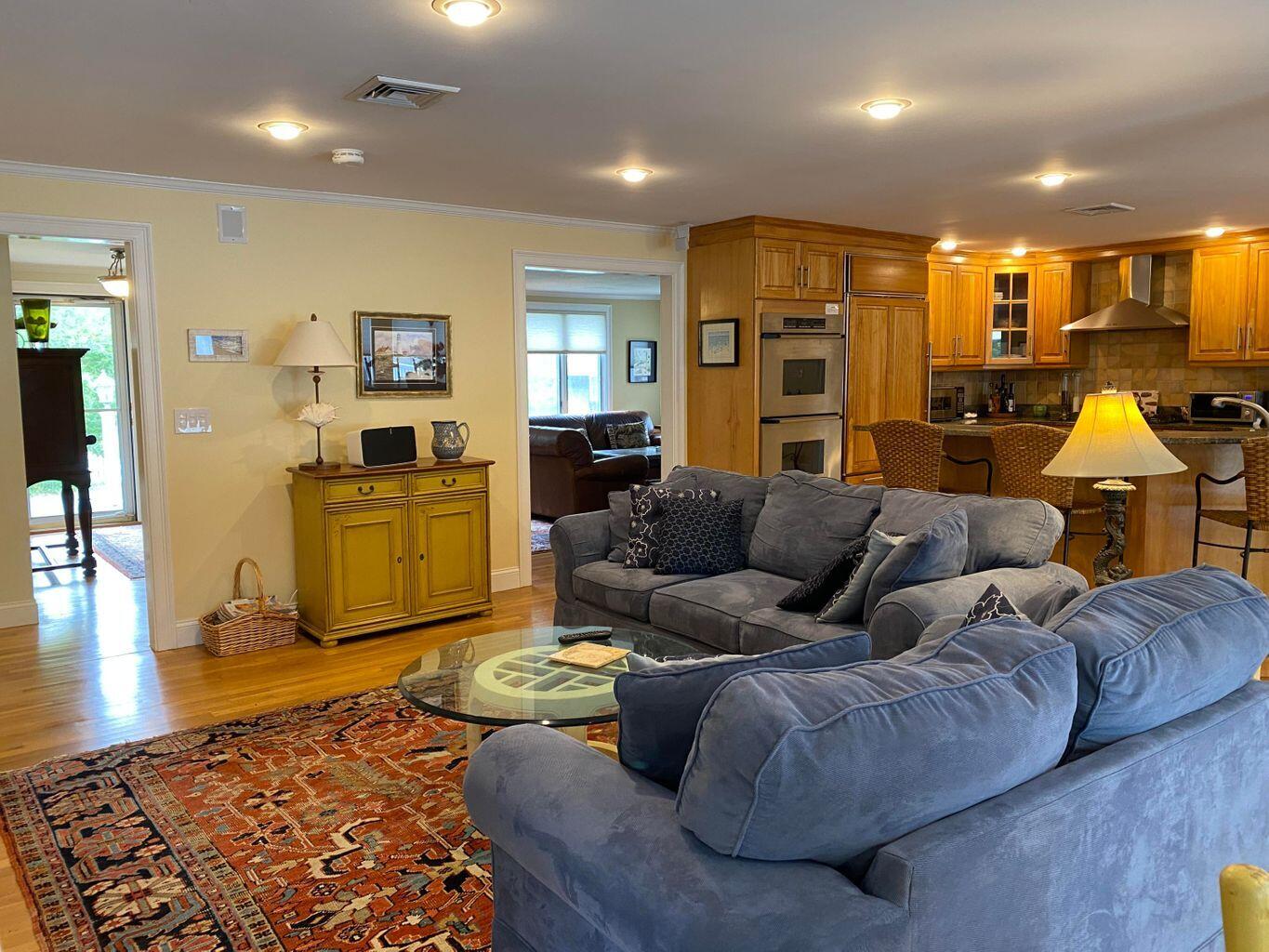 44 Island View Road Hyannis, MA 02601 - Photo 9 of 33 a living room with couches and kitchen view with wooden floor