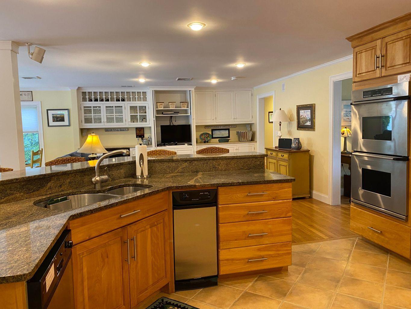 44 Island View Road Hyannis, MA 02601 - Photo 10 of 33 a kitchen with stainless steel appliances granite countertop a stove refrigerator and cabinets