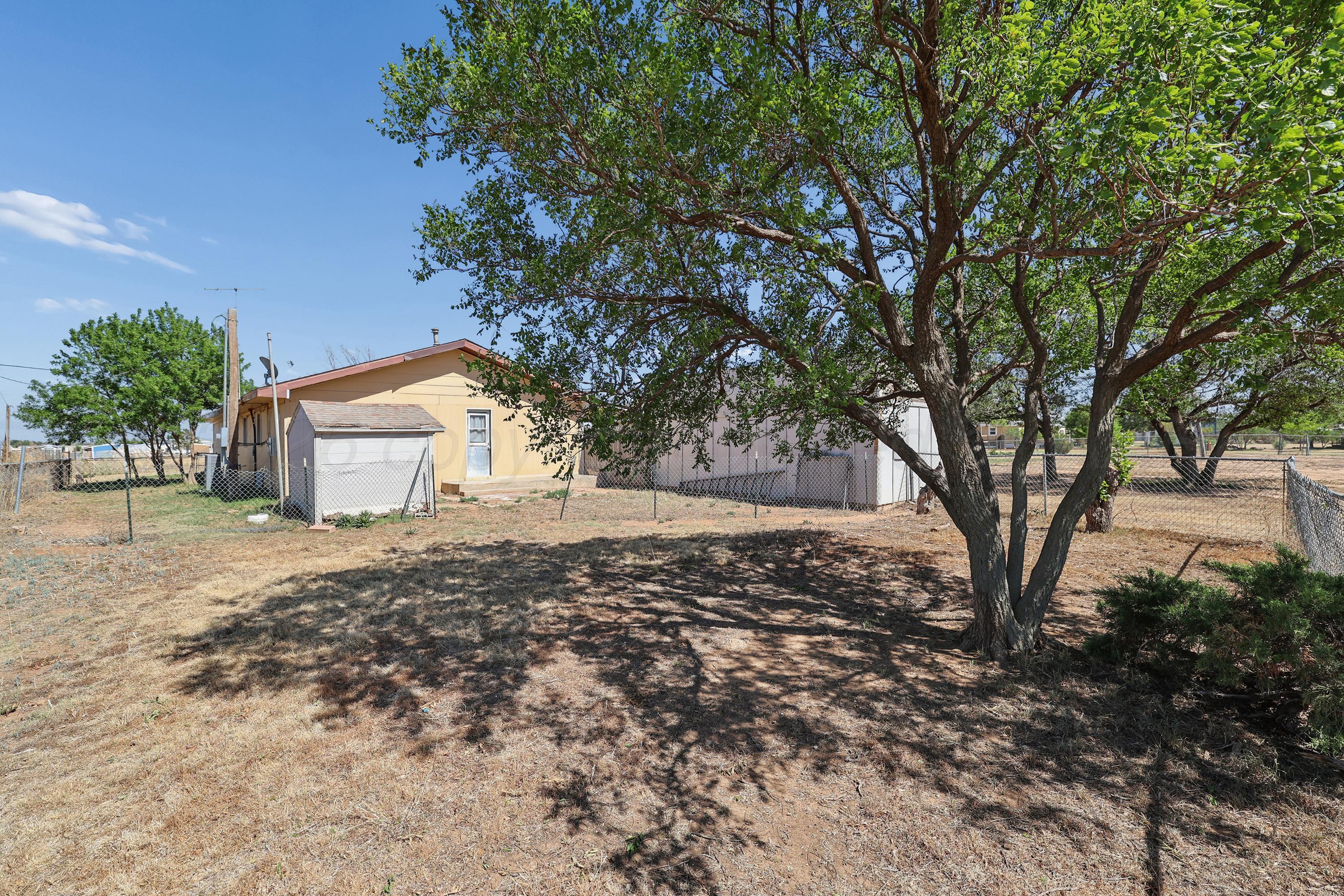 14200 Savannah Road Amarillo, TX 79118 - Photo 27 of 34 a view of a backyard with large trees