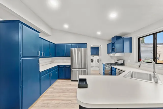 a kitchen with refrigerator and cabinets