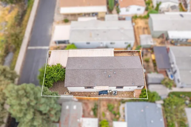 an aerial view of a house with a yard