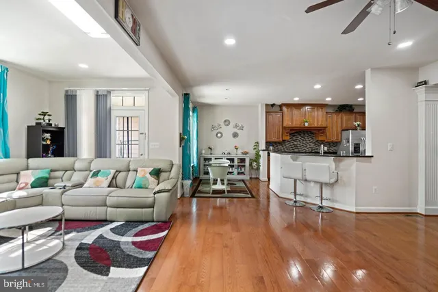 a living room with furniture and kitchen view