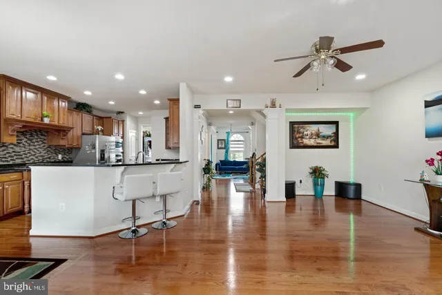 a living room with furniture and kitchen view