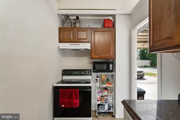 a kitchen with stainless steel appliances granite countertop a stove a refrigerator and a microwave