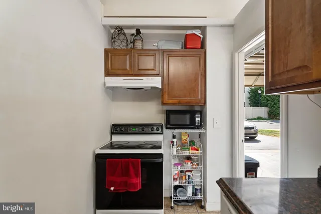 a kitchen with stainless steel appliances granite countertop a stove a refrigerator and a microwave