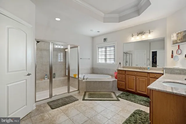 a spacious bathroom with a mirror a sink and a shower