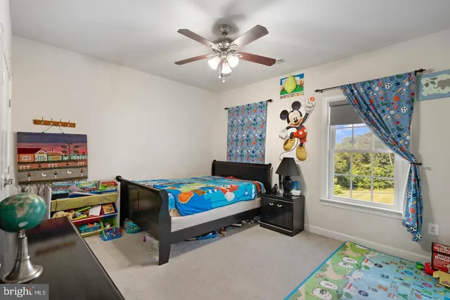 a living room with furniture and a baby crib
