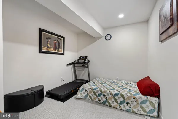 a bedroom with a bed and a lamp on the table