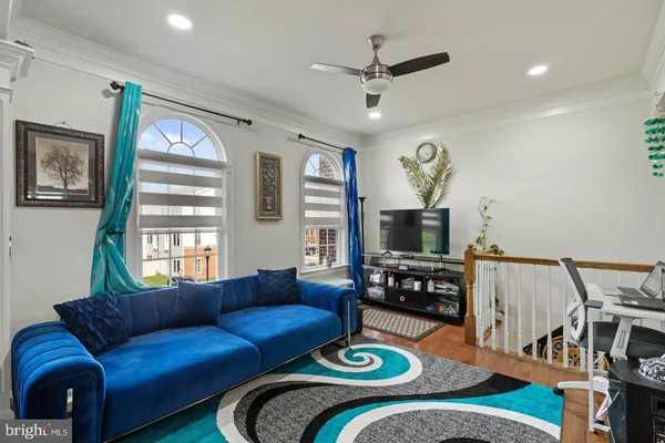 a living room with furniture fireplace and a window