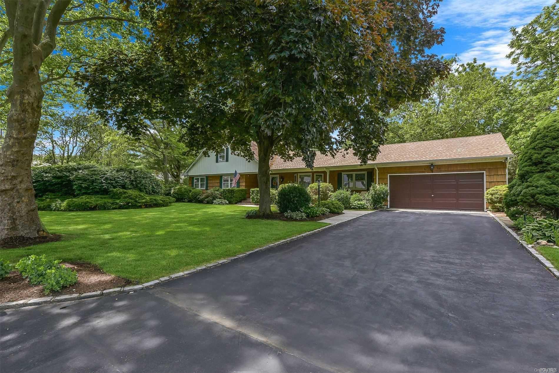 a front view of a house with a yard and a garage