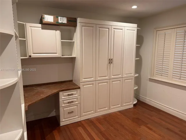 a view of cabinets and wooden floor