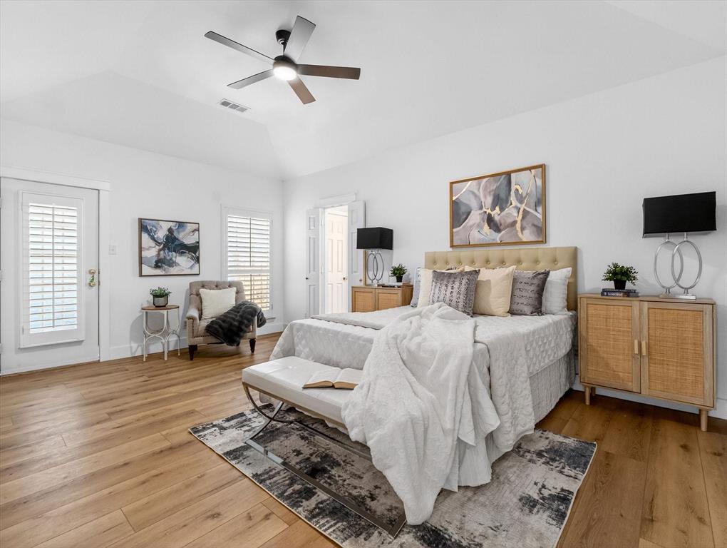 4345 Timberglen Road Dallas, TX 75287 - Photo 14 of 26 a bedroom with a bed and wooden floor