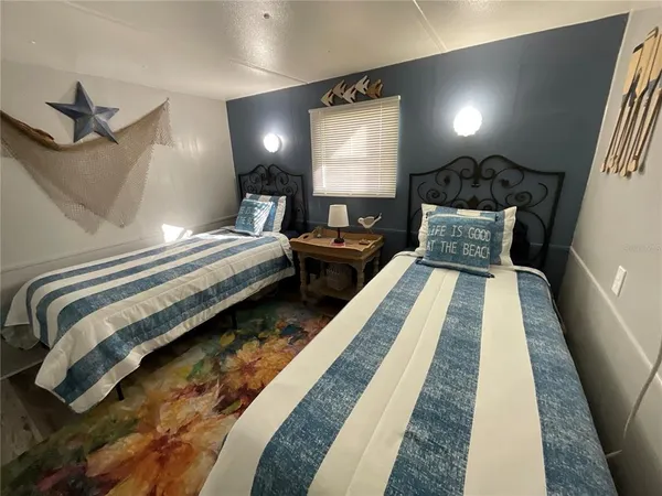 a bed room with a bed lamp and a fireplace