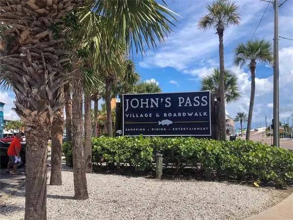 a palm tree sitting in front of a building with palm trees
