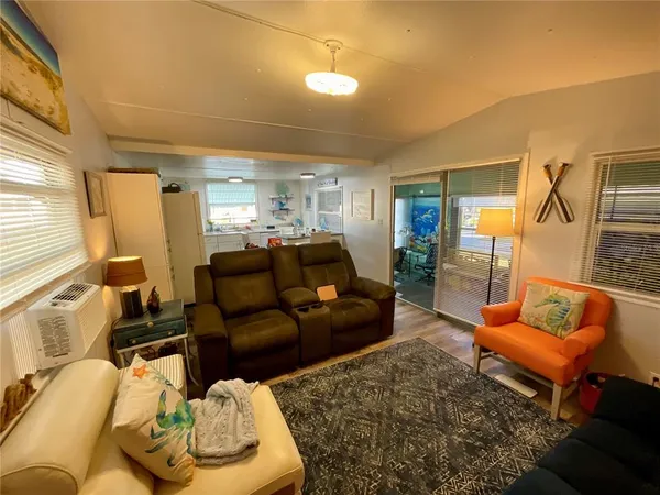 a living room with furniture and a lamp