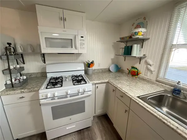 a kitchen with cabinets a stove and a sink