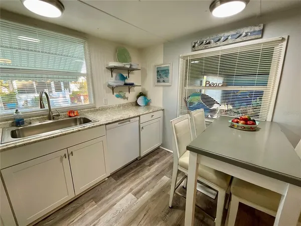 a kitchen with a sink cabinets and window