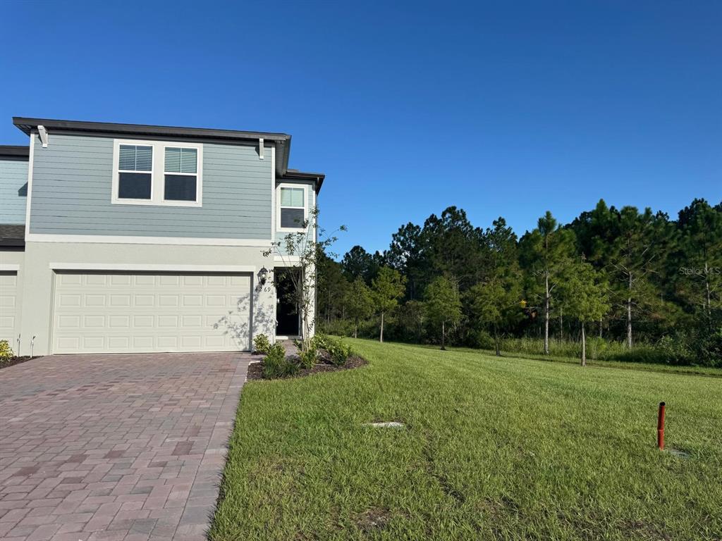 4269 Ranch House Road St. Cloud, FL 34772 - Photo 1 of 1 a front view of a house with a yard and trees