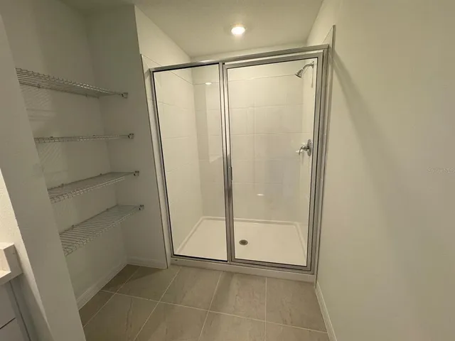 a bathroom with a glass shower door