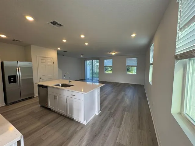 a kitchen with a stove and a wooden floors