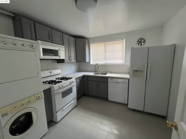 a kitchen with a sink a stove a microwave and refrigerator