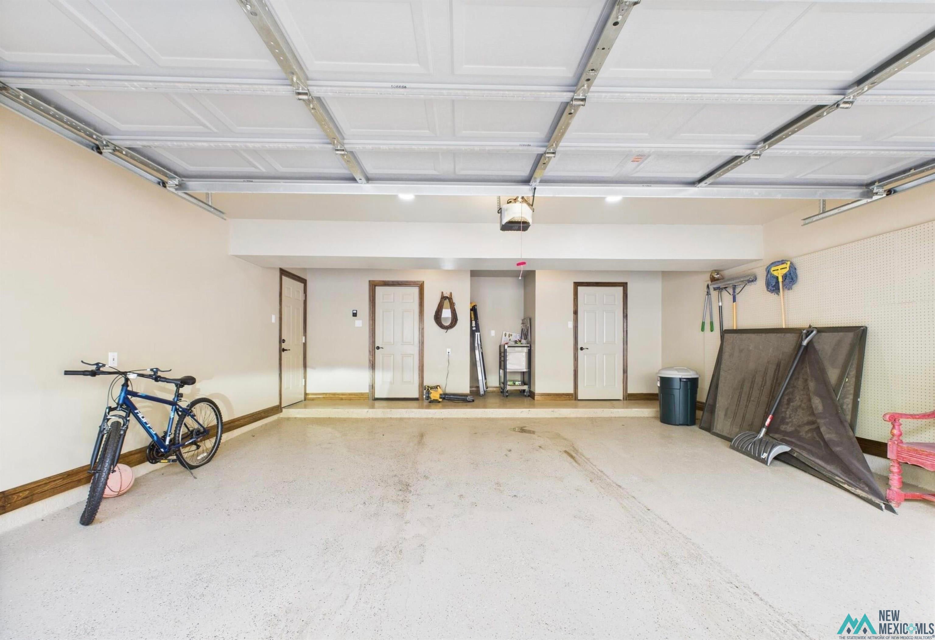 103 Granite Drive Ruidoso, NM 88345 - Photo 28 of 28 Spacious garage with textured flooring, neutral wall tones, and overhead lighting