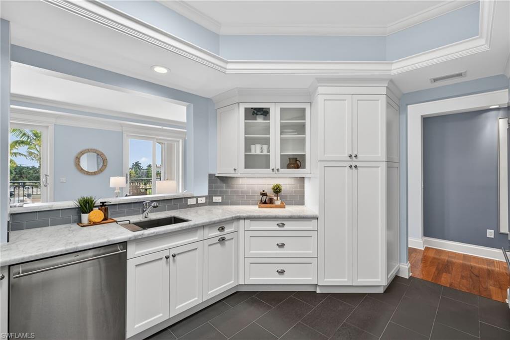 625 5th Avenue South, Unit PH302 Naples, FL 34102 - Photo 11 of 33 Kitchen with dishwasher, dark tile patterned floors, white cabinets, decorative backsplash, and recessed lighting