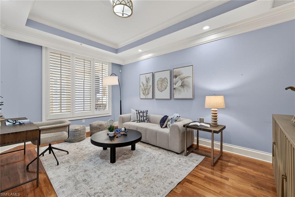 625 5th Avenue South, Unit PH302 Naples, FL 34102 - Photo 13 of 33 Living area with wood finished floors, ornamental molding, recessed lighting, and a tray ceiling