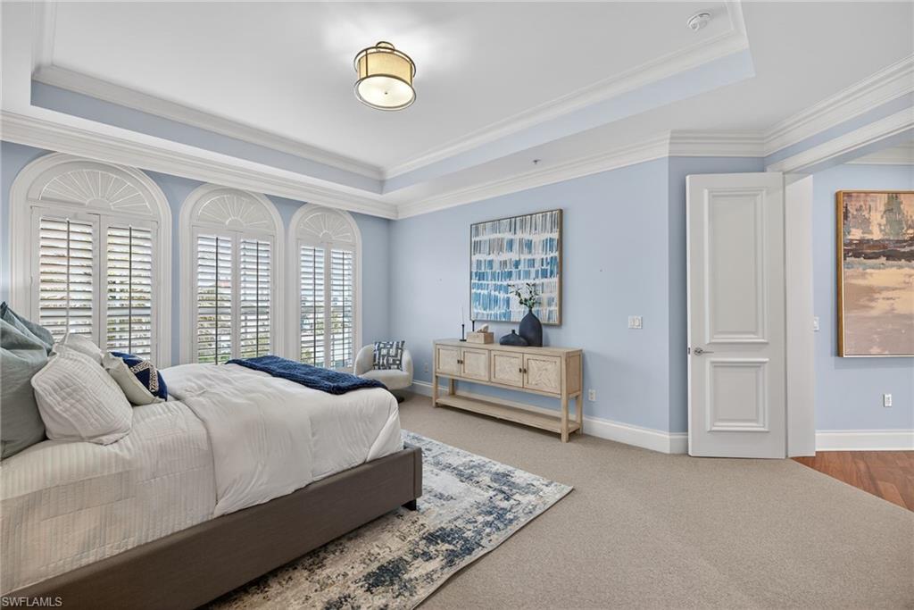 625 5th Avenue South, Unit PH302 Naples, FL 34102 - Photo 17 of 33 Bedroom with carpet, ornamental molding, and a raised ceiling
