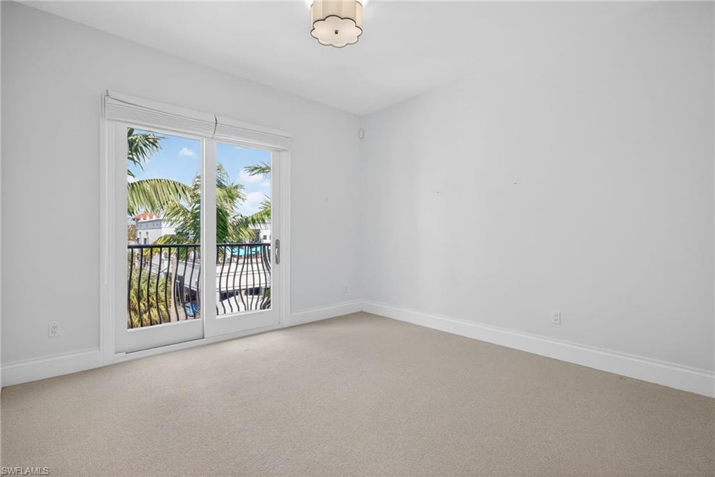 625 5th Avenue South, Unit PH302 Naples, FL 34102 - Photo 22 of 33 Unfurnished room featuring carpet flooring and baseboards