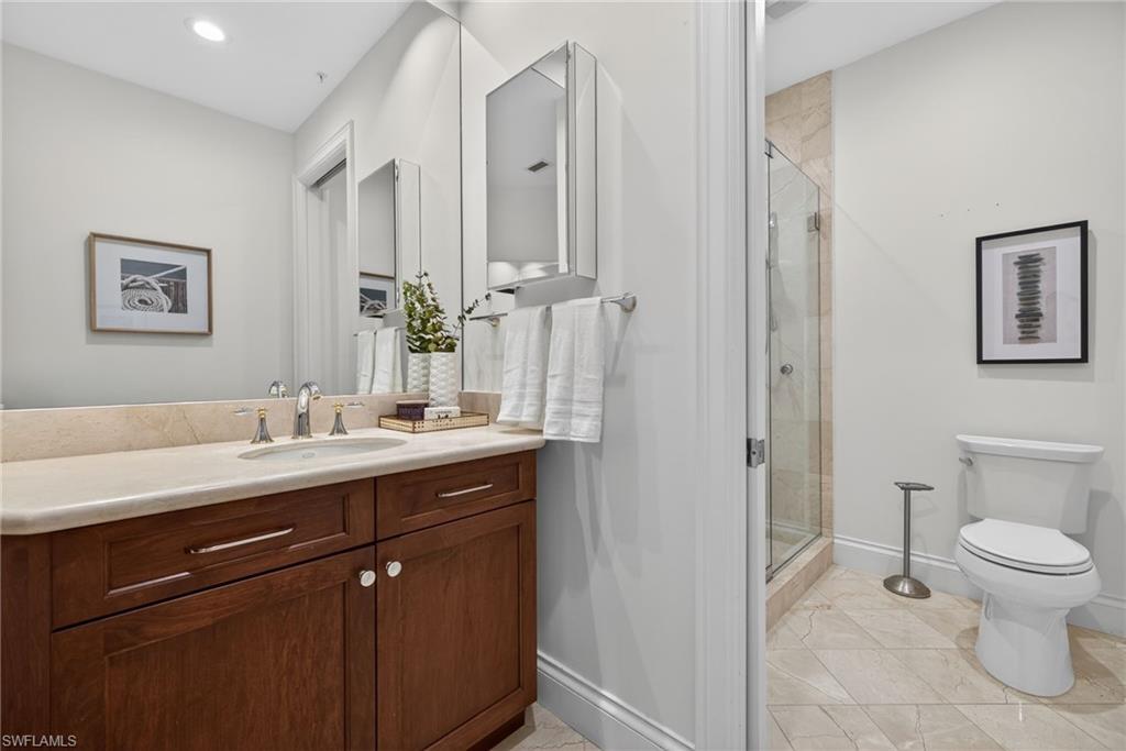 625 5th Avenue South, Unit PH302 Naples, FL 34102 - Photo 23 of 33 Full bath featuring a stall shower, vanity, recessed lighting, and light tile patterned floors