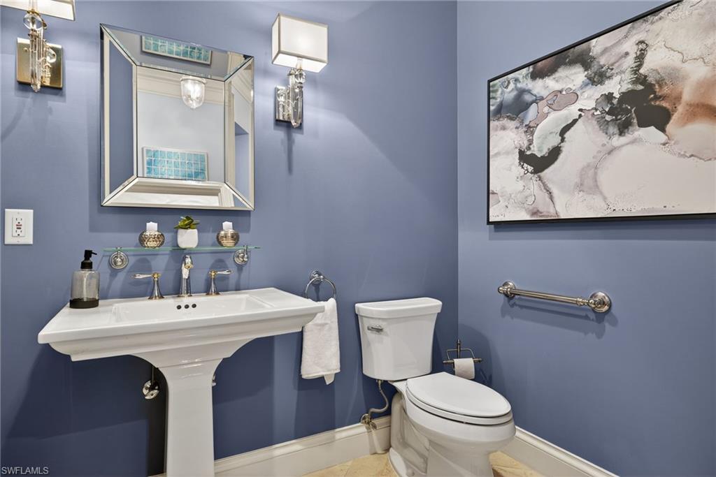 625 5th Avenue South, Unit PH302 Naples, FL 34102 - Photo 25 of 33 Bathroom with toilet and baseboards