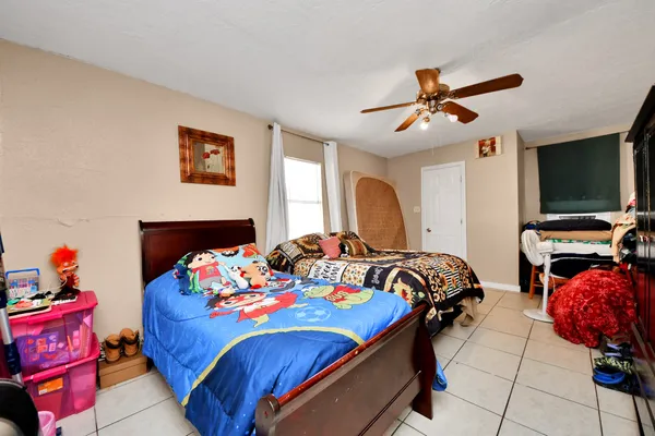 a bedroom with a bed and dresser