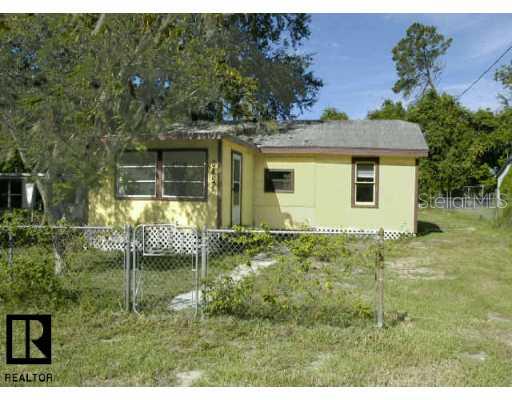 6451 Santee Court New Port Richey, FL 34653 - Photo 1 of 1 a backyard of a house with plants and large tree